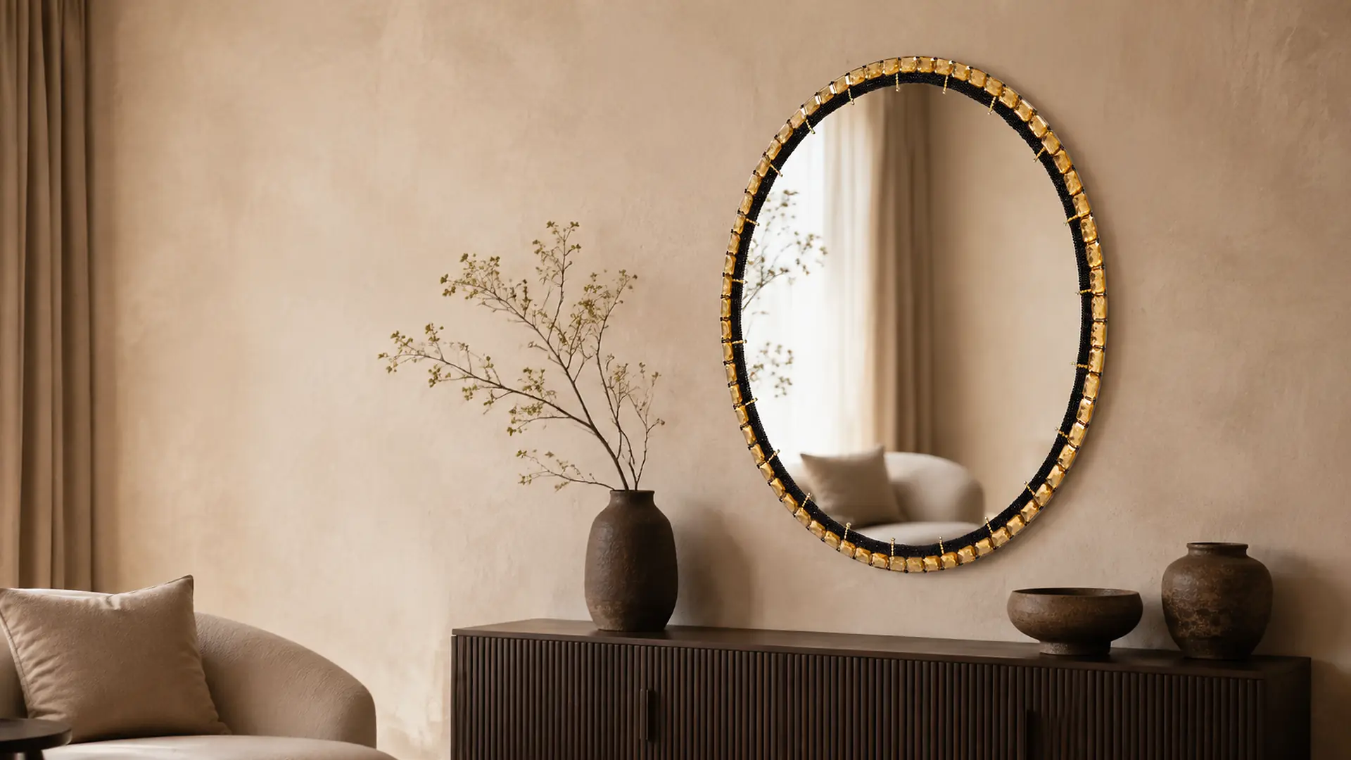Handcrafted oval Jo.Sa statement mirror with black beading and amber stones displayed in an earthy luxury interior
