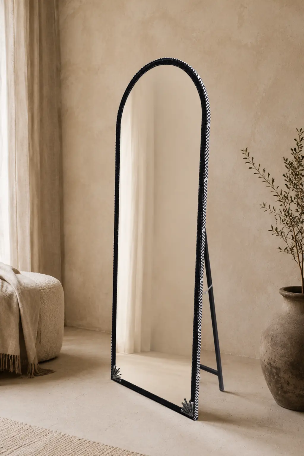 Tall black handcrafted Jo.Sa arched mirror displayed in a contemporary interior